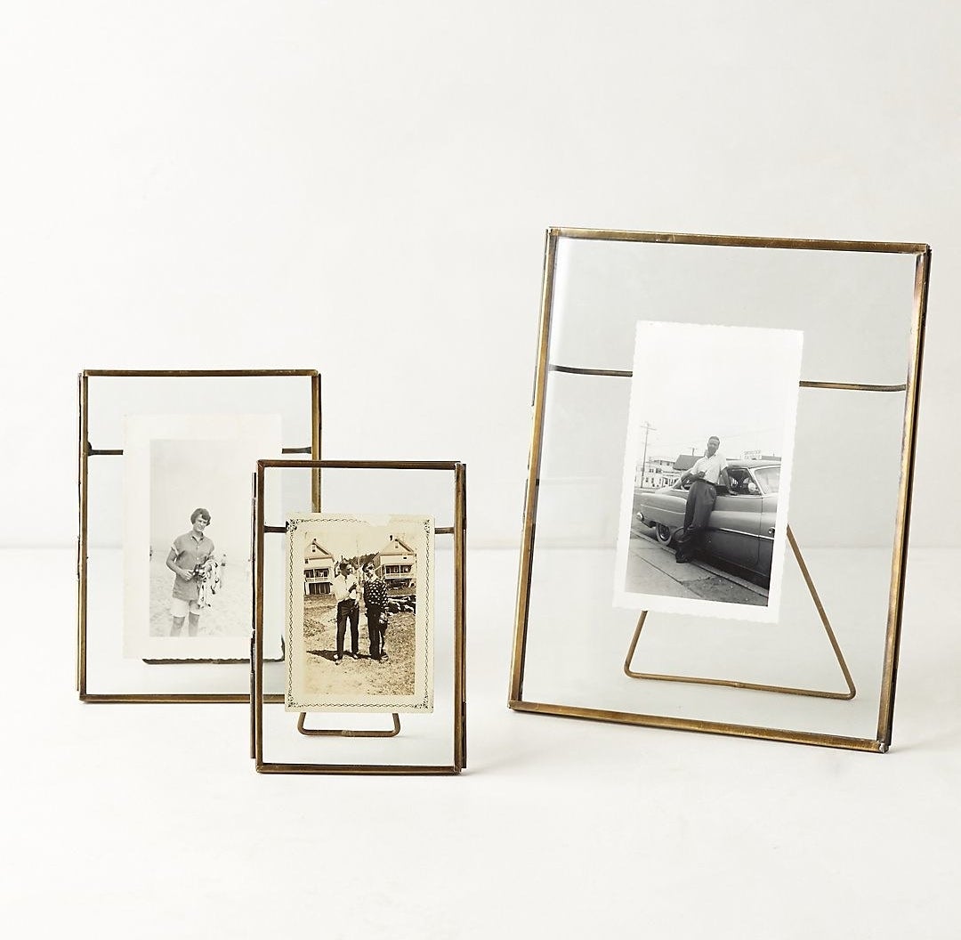 three different sized pressed glass frames with black and white photos inside
