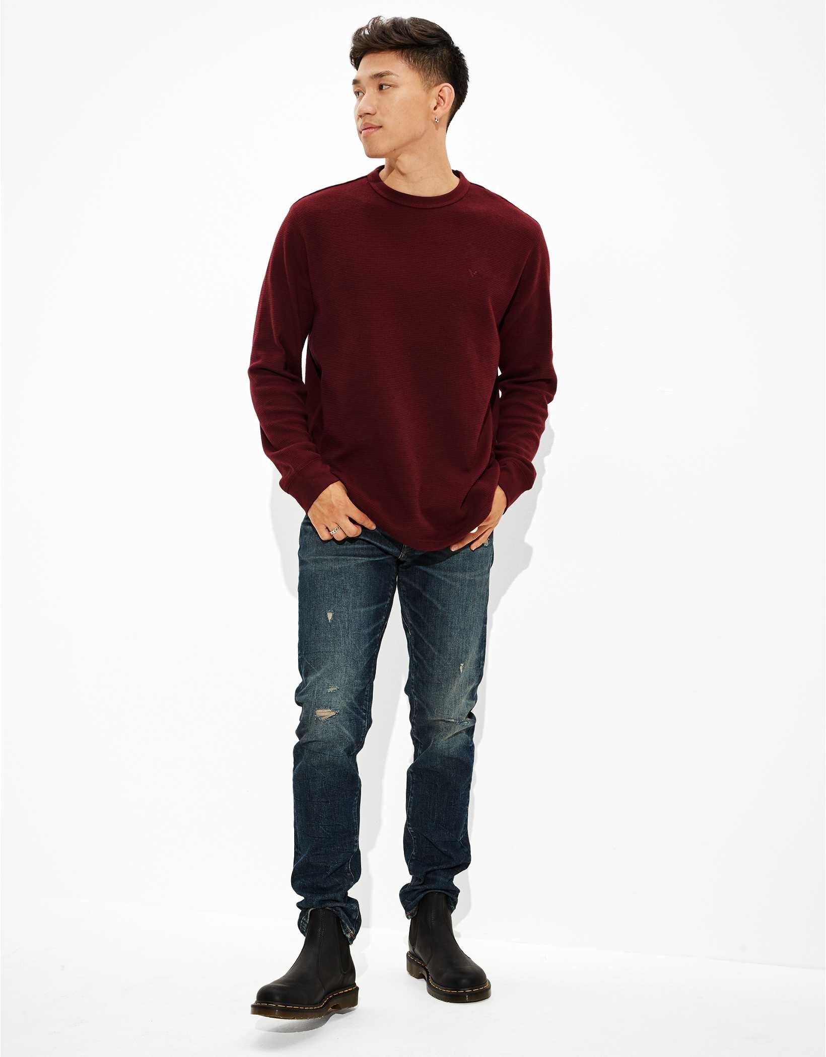 A model wearing the red long sleeve with jeans