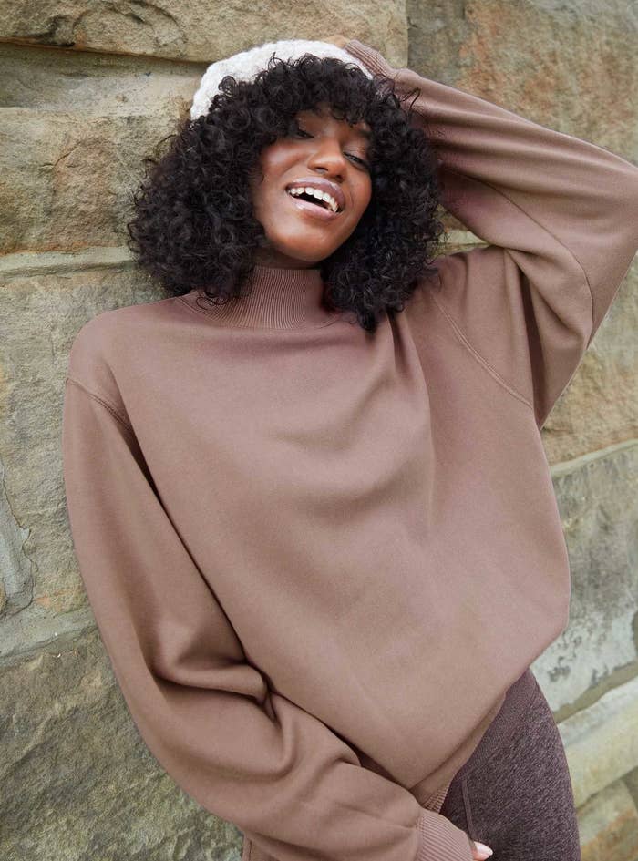 model in the sweatshirt in brown