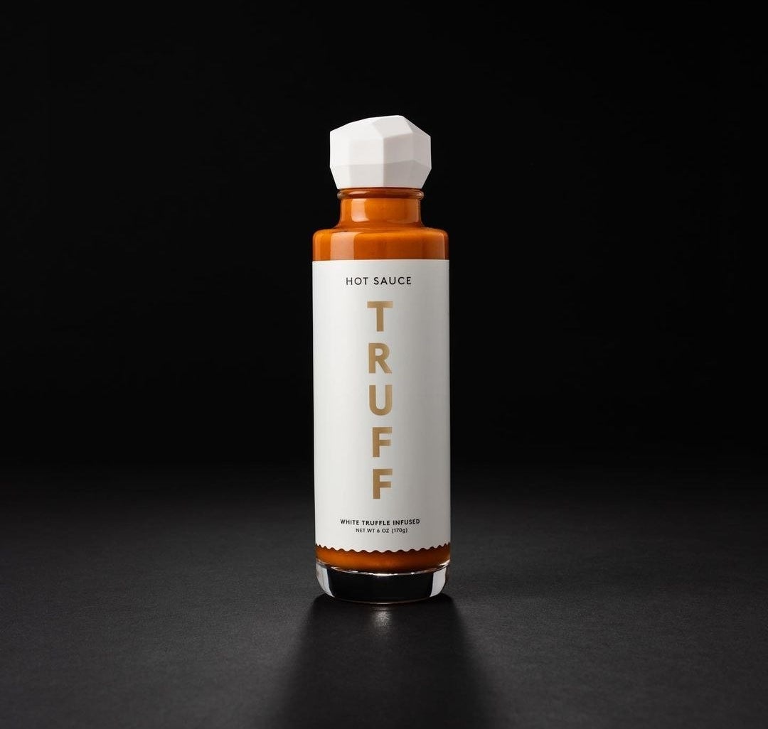 a bottle of the white truffle sauce against a contrasting background