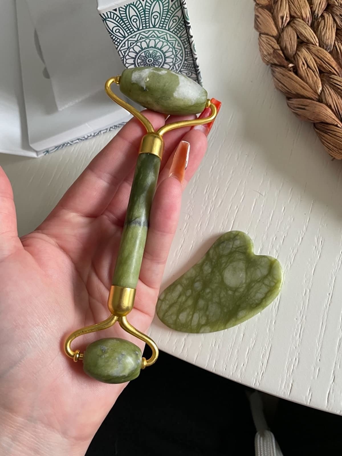 reviewer holding the jade roller