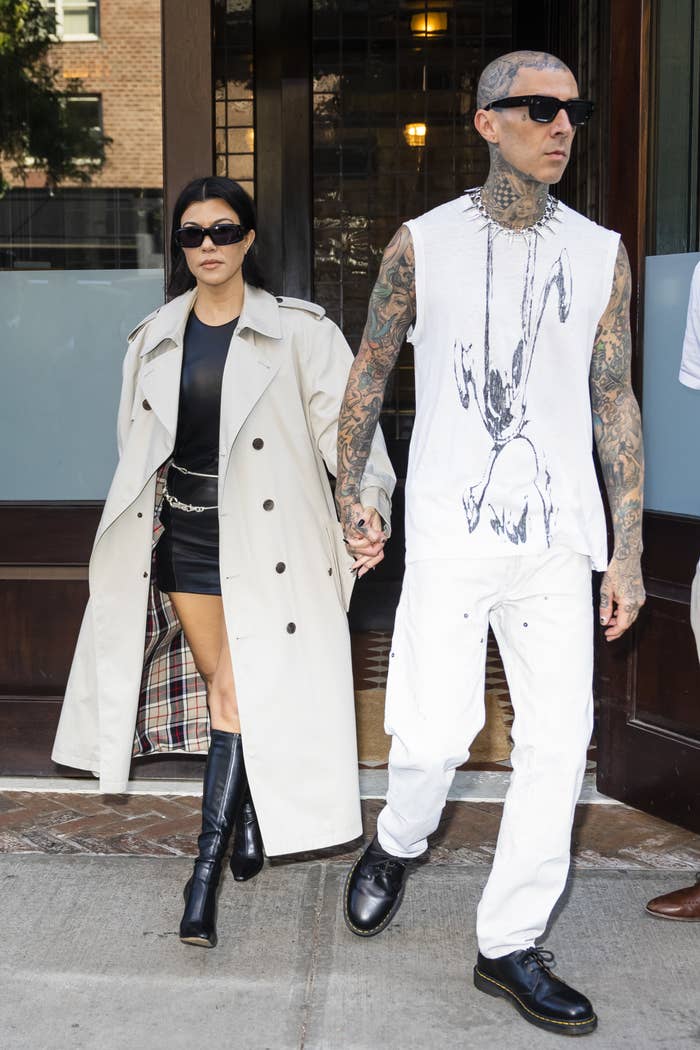 Kourtney and Travis leaving a building hand-in-hand