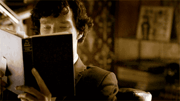 Sherlock looking up from his book