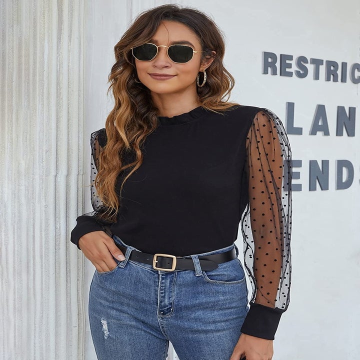 Model wearing the black mock neck top