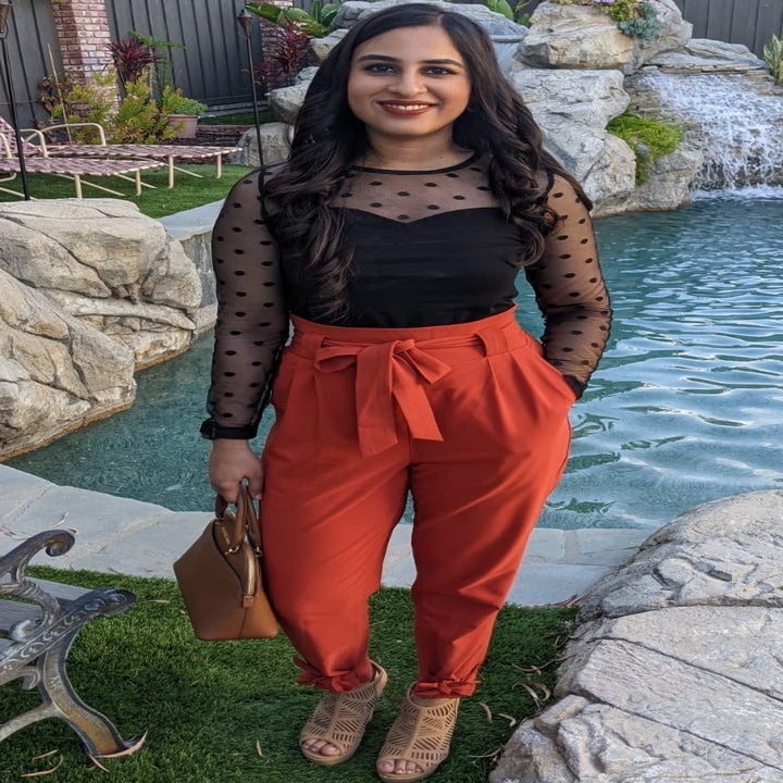 Reviewer wearing the red high-waisted pants