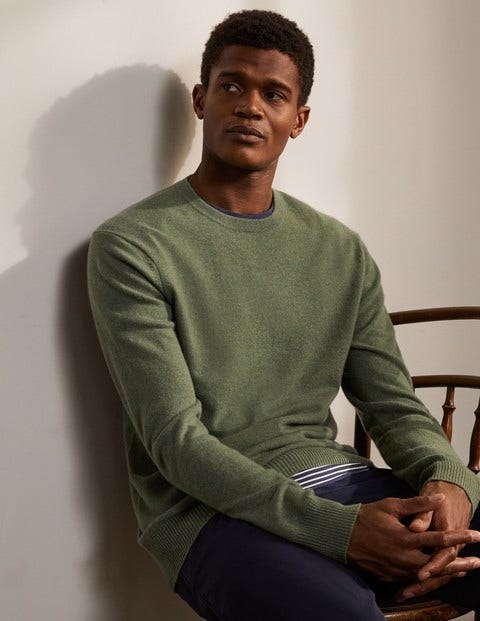 Model wearing the crewneck sweater in green