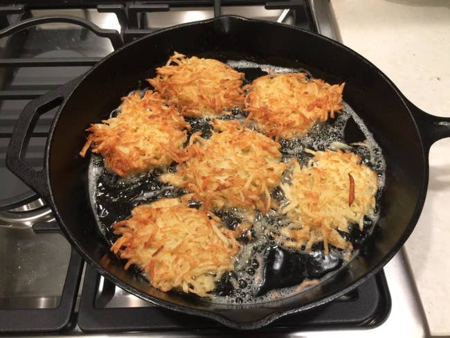 Reviewer image of latkes cooking in the skillet