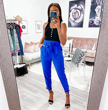 Reviewer wearing the blue high-waisted pants