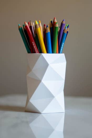 A reviewer's image of colored pencils in the container