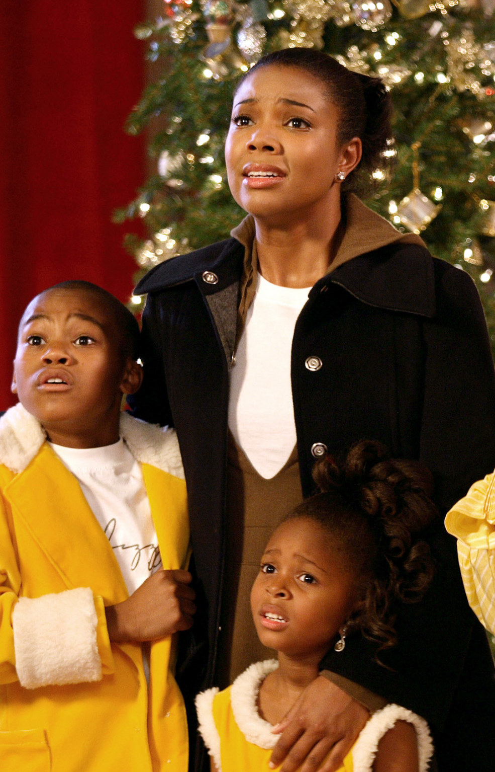 Union standing with a worried expression on her face while holding onto her two kids in the film