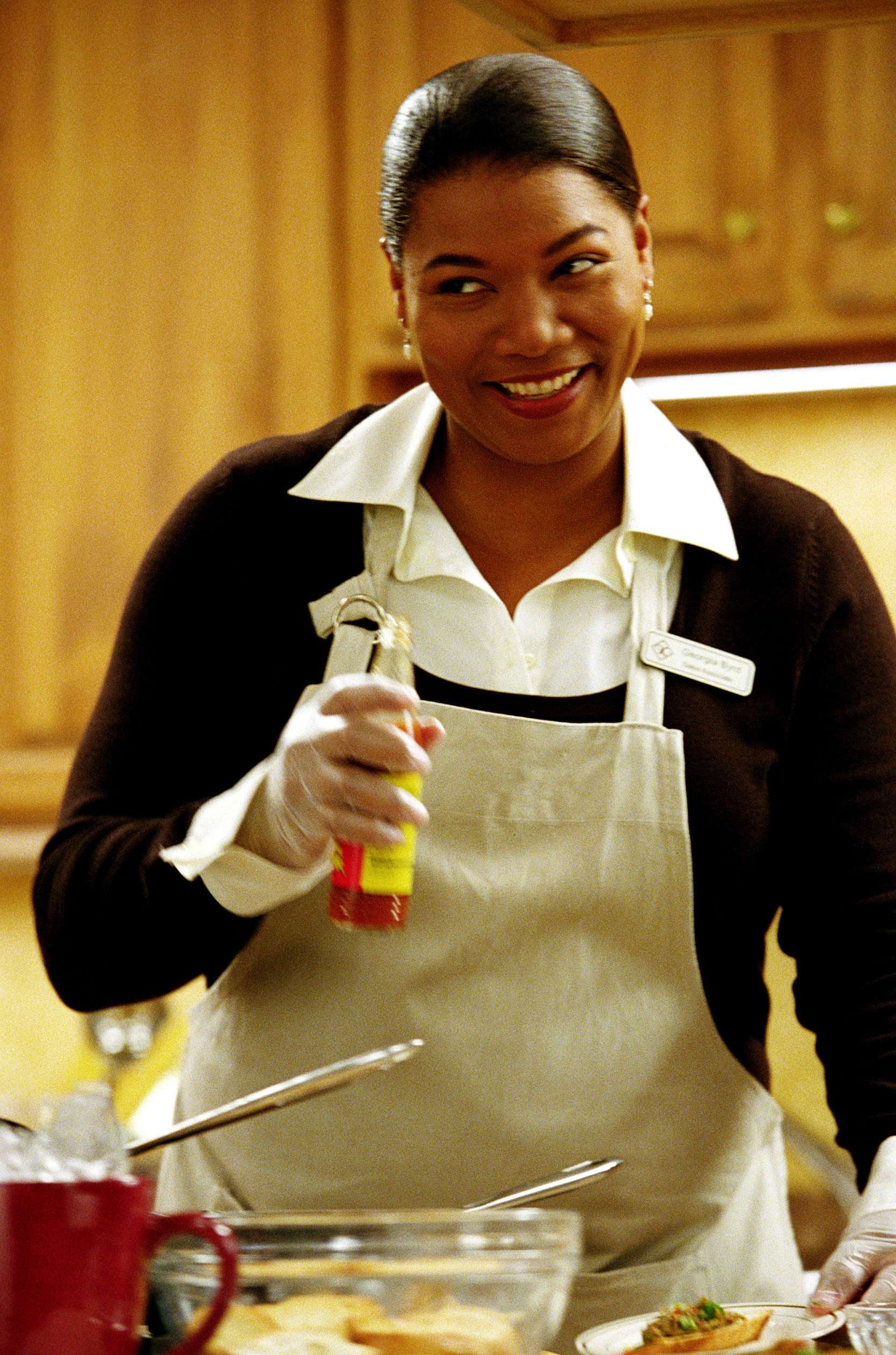Latifah happily cooking a meal