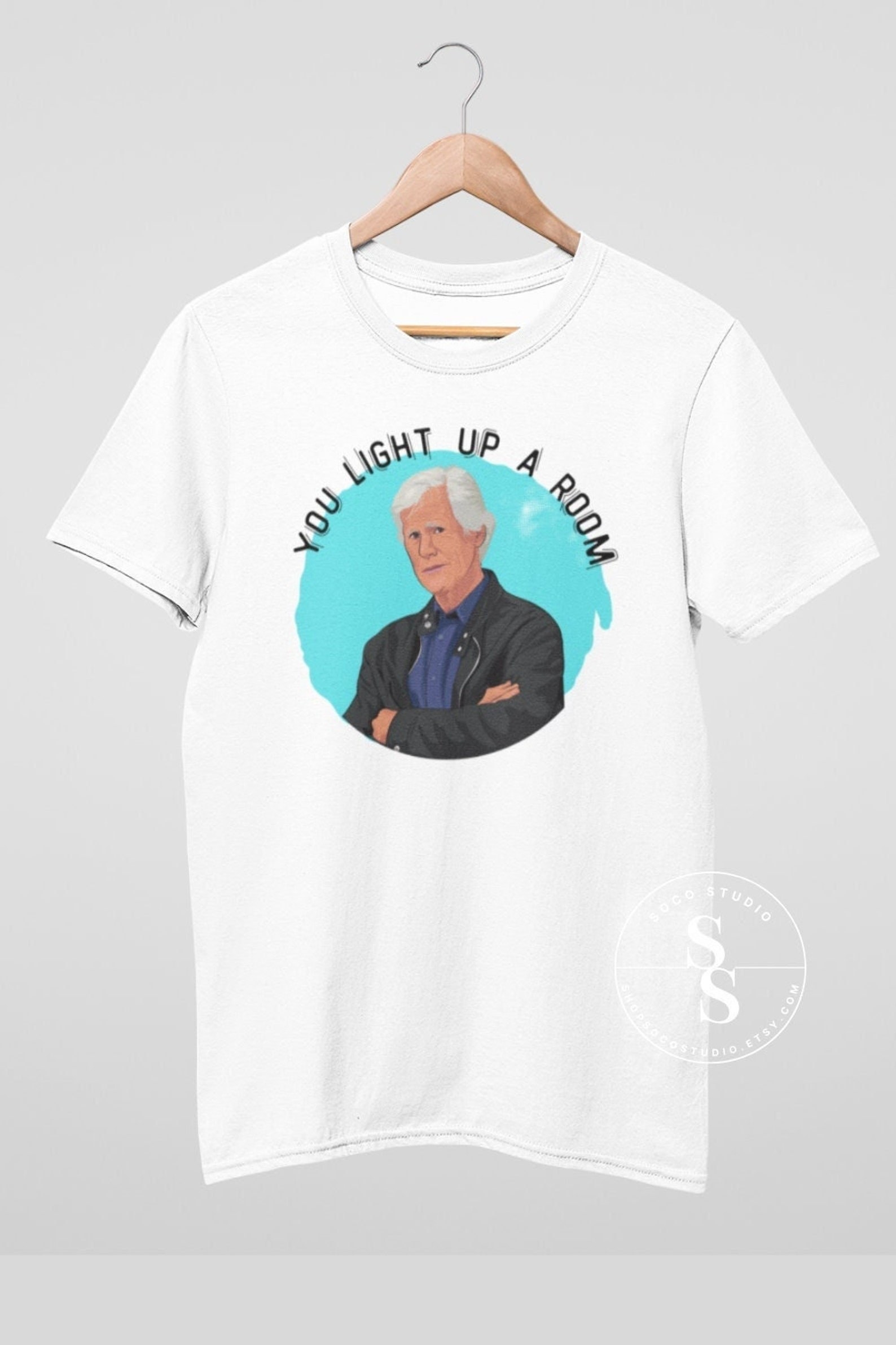 A white tee with Keith Morrison&#x27;s face and text &quot;you light up a room&quot;