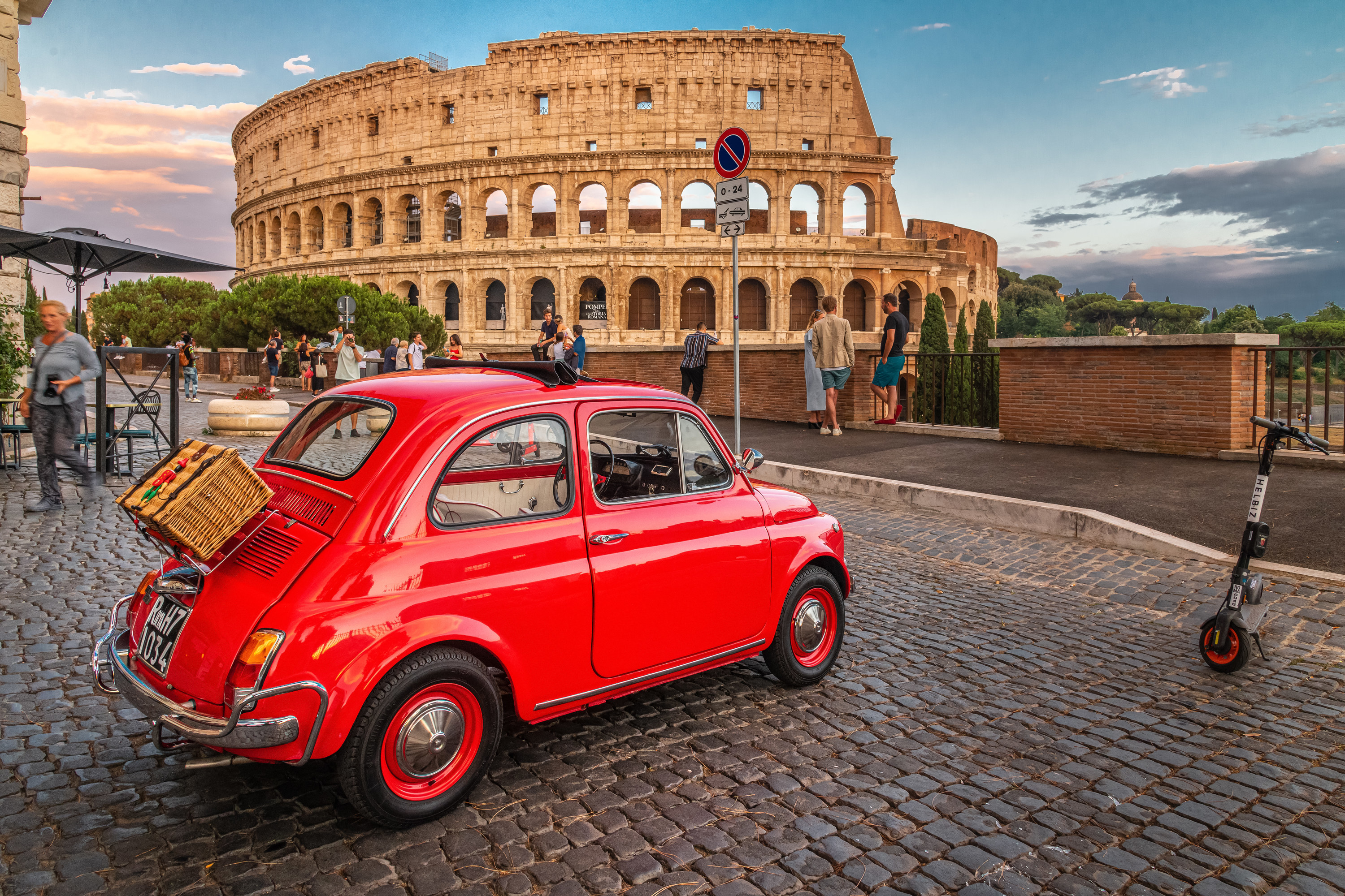 Small Italian car parked near the Collosseum