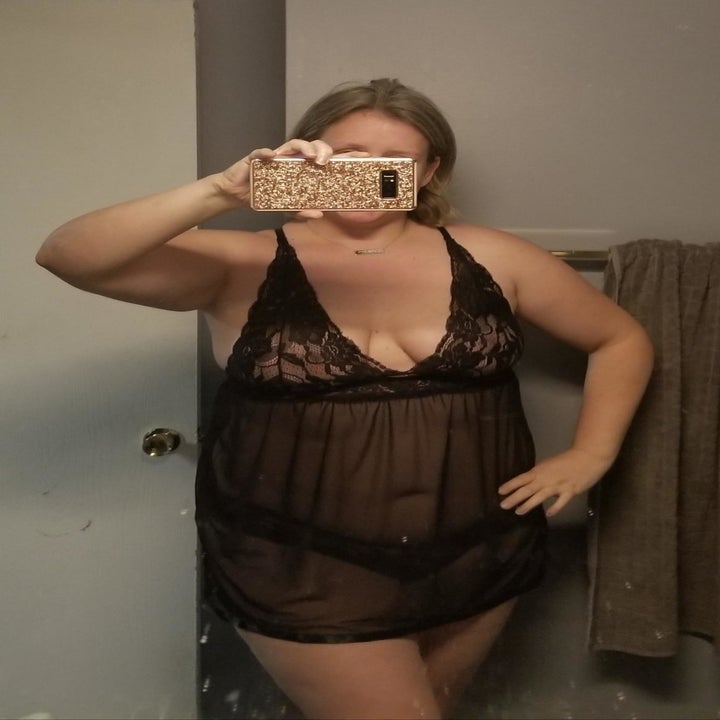 A customer review photo of them taking a mirror selfie while wearing the set in black