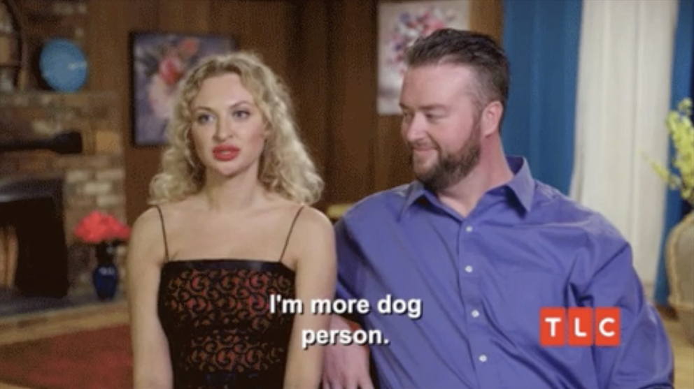 A woman sits next to her fiancé ad says &quot;I&#x27;m more dog person&quot;