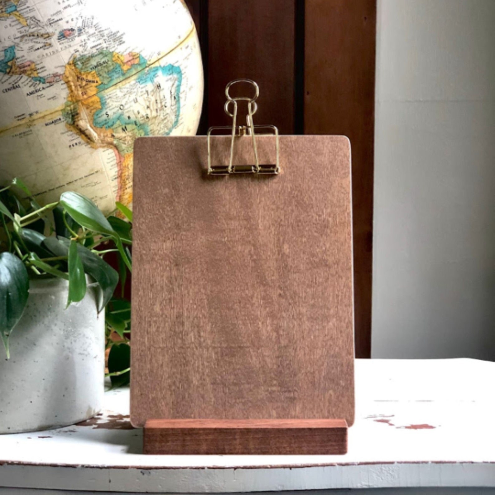 The rectangle-shaped clipboard with gold tone clip at top