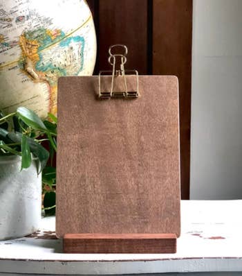 The rectangle-shaped clipboard with gold tone clip at top