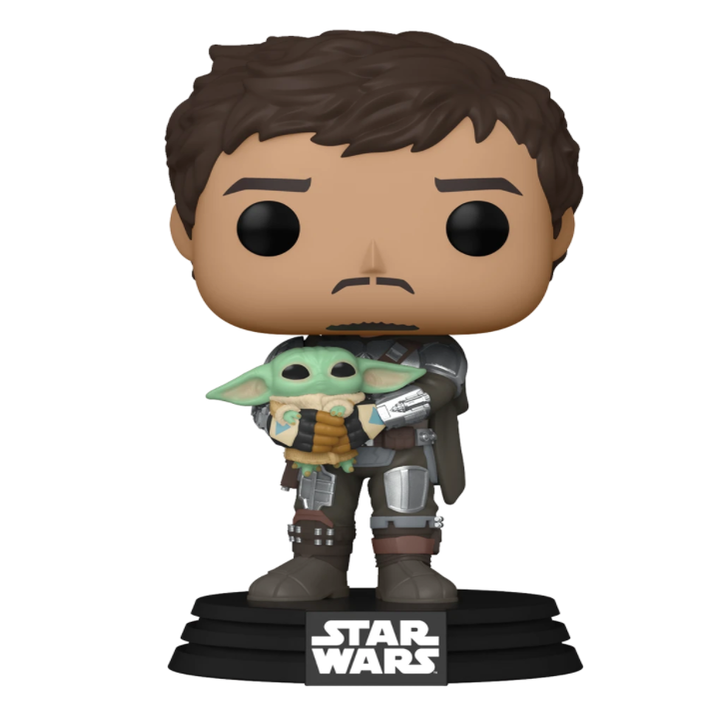 The Mandalorian, without his helmet, holding little Grogu