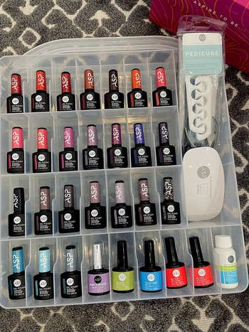 The same organizer, opened to reveal nail polish bottles in every compartment