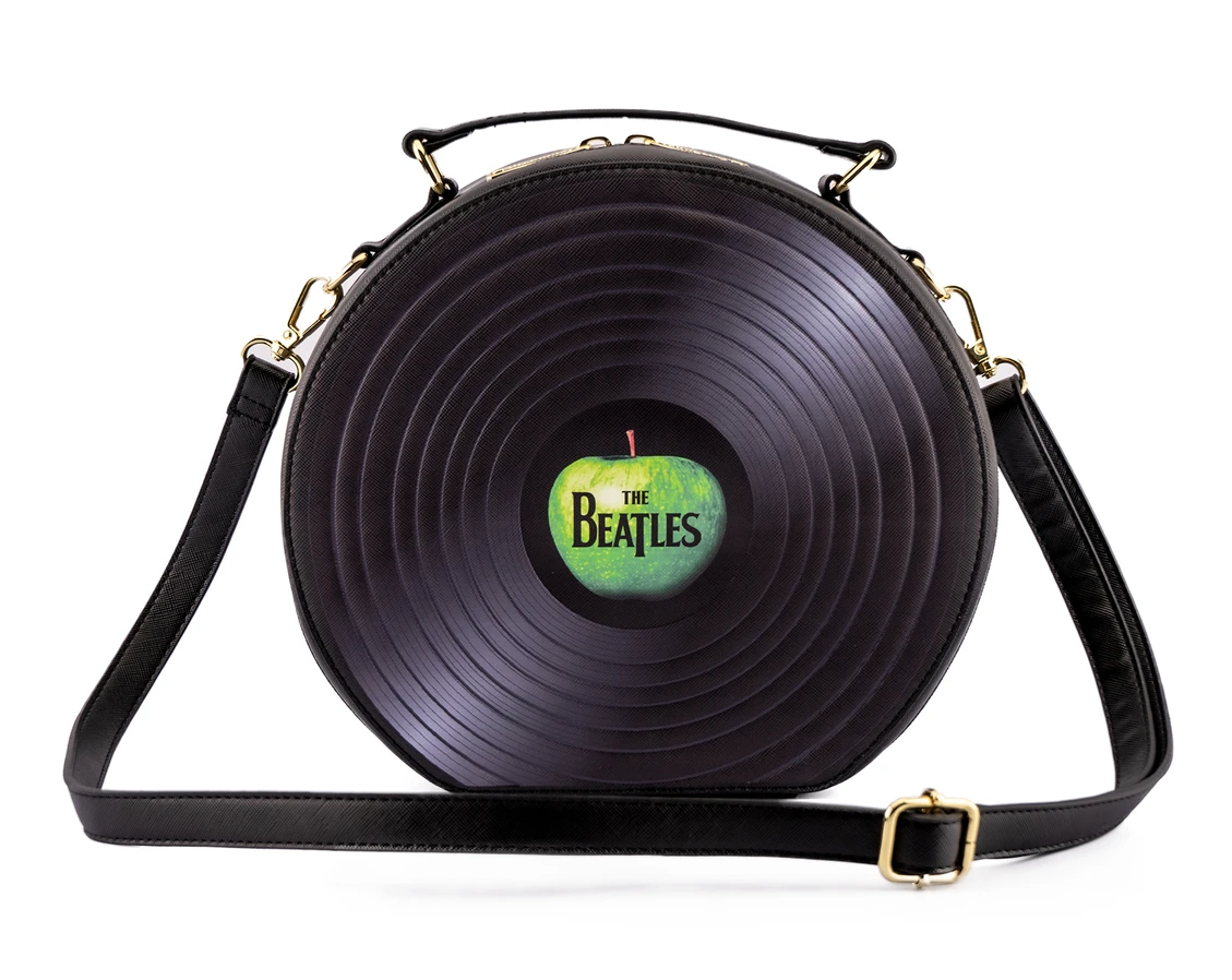 A crossbody bag shaped like a vinyl record with the beatles let it be apple record logo in the middle