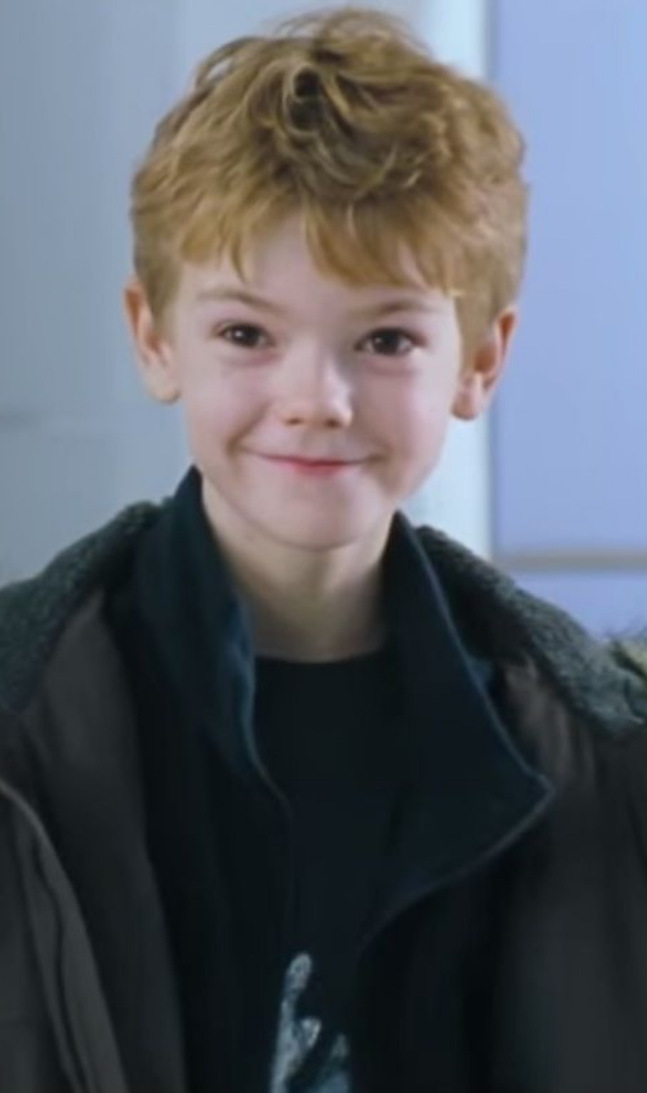 Brodie-Sangster smiling cutely in the airport scene
