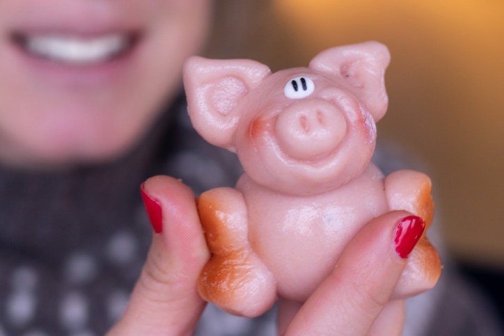 Someone holding a pig made of marzipan