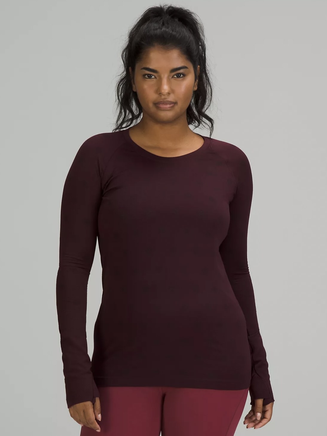 front view of model wearing the long sleeve t-shirt in a red wine color