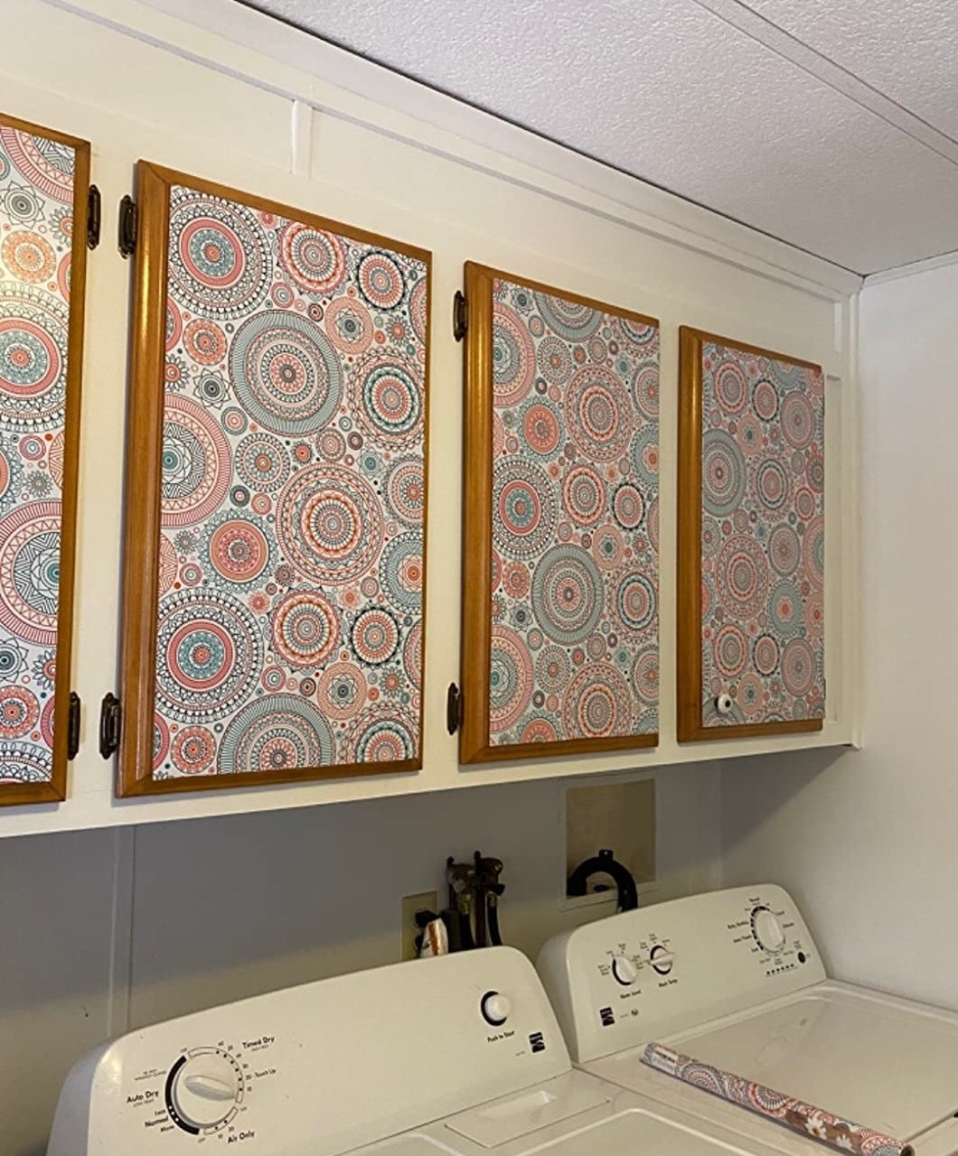 Reviewer image of coral, blue, and white medallion wallpaper in laundry room