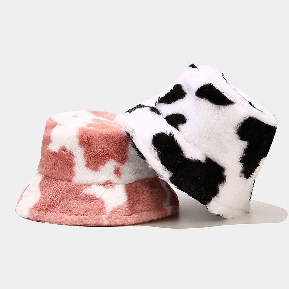 a pair of fuzzy cow-print bucket hats