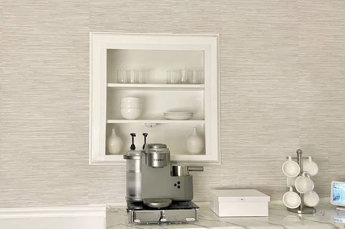 Taupe textured wallpaper behind coffee machine