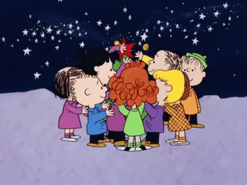 Peanuts characters surround a Christmas tree