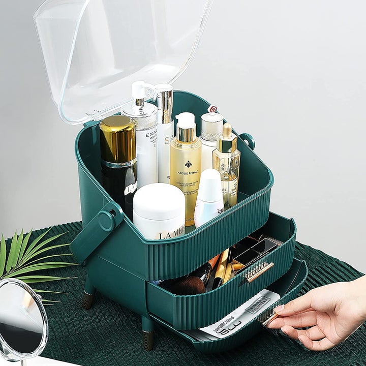 the green makeup organizer with drawers open and cover off