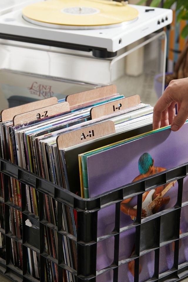 a crate full of records with the wooden dividers separating them