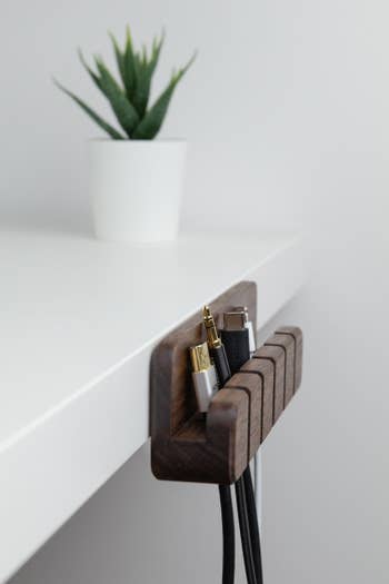 The same organizer attached to the side of a white desk instead of on top