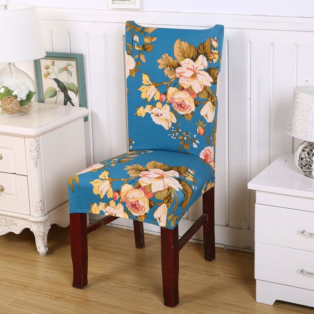 A blue floral chair cover on a chair next to a wadrobe