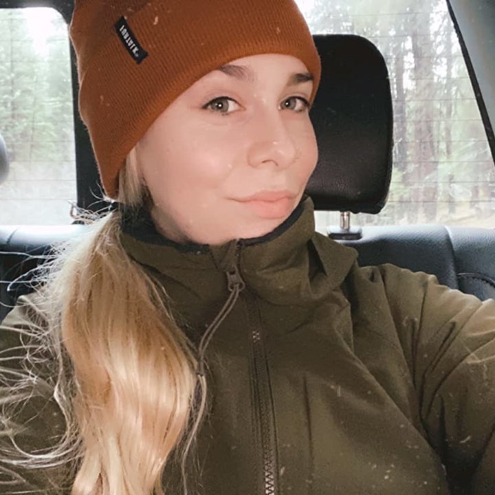 Reviewer wearing beanie in rust orange