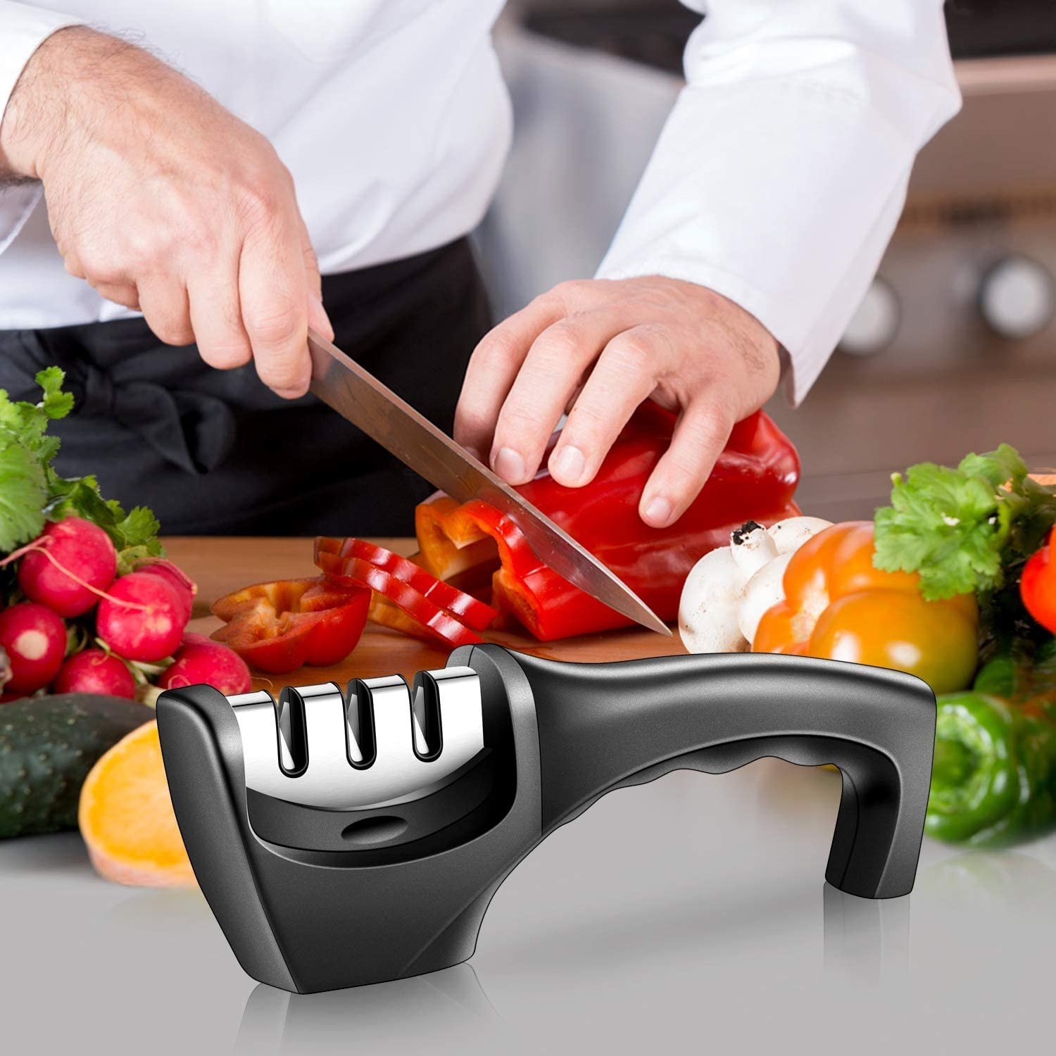 A person chopping up a capsicum with a knife sharpener near it