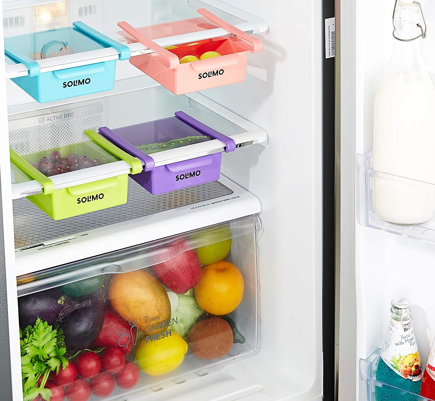 A set of under-shelf organisers with food items in them in a fridge