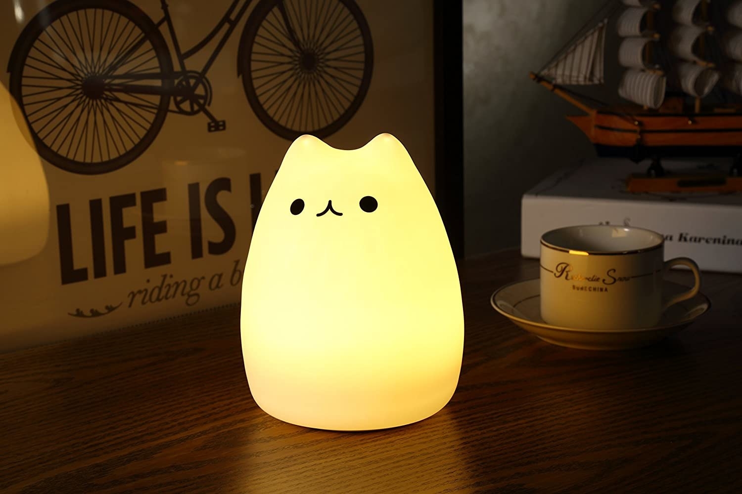 silicone cat night light lit up on a table