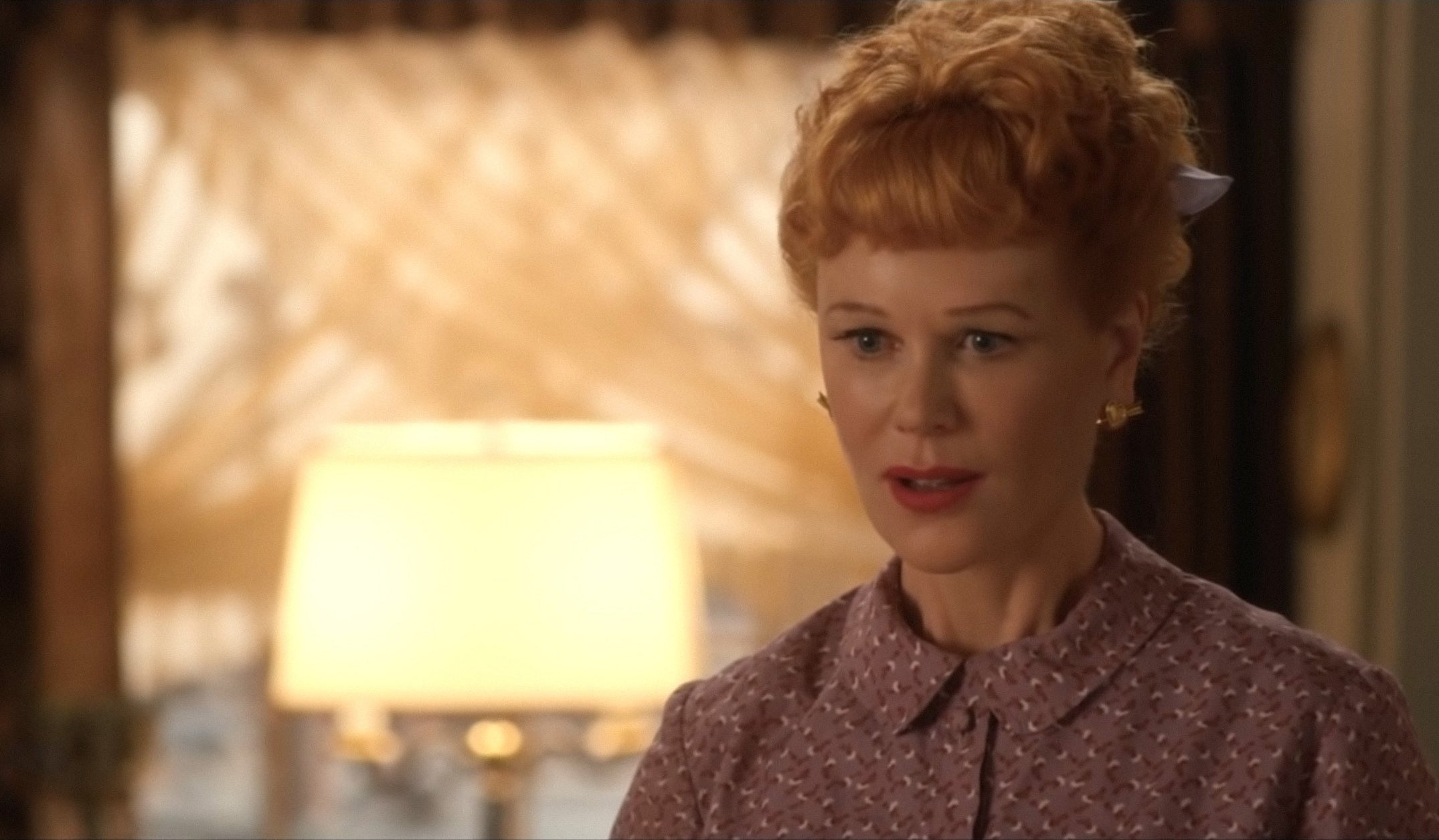 Nicole Kidman as redhead Lucille Ball, with bangs and an updo