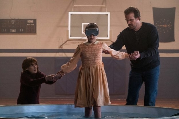 Joyce Byers and Hopper help Eleven into the saltwater pool in season 1