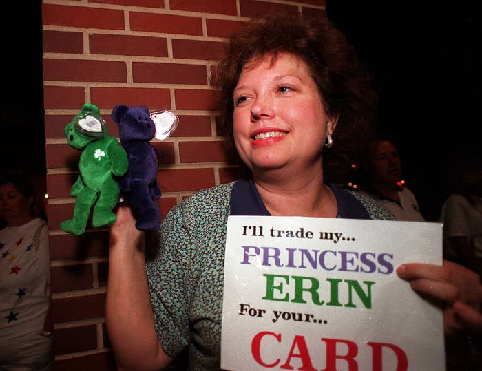 A woman holding up two beanie babies