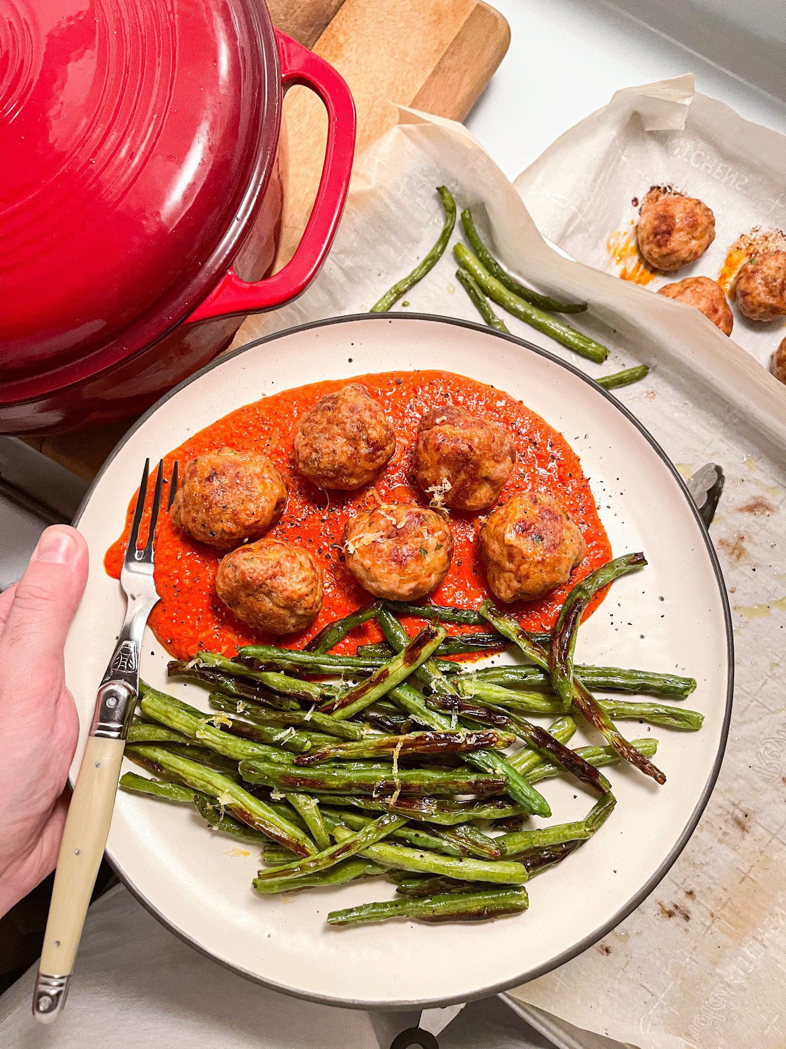 Turkey Meatballs with Romesco sauce and green beans on a plate