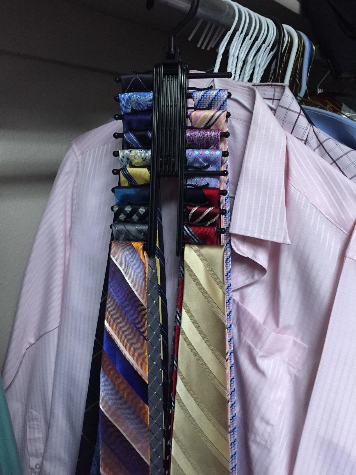 Reviewer shows tie rack holder with different colored ties in their closet
