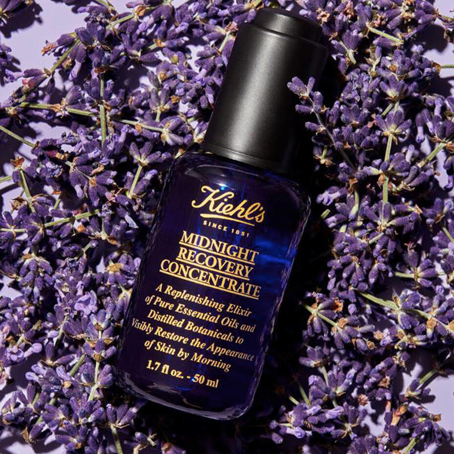 a bottle of midnight recovery concentrate in a bed of lavender