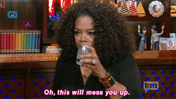 Oprah Winfrey drinking a cocktail.