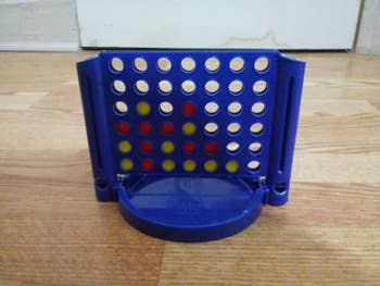 reviewer's photo showing the blue game with red and yellow discs