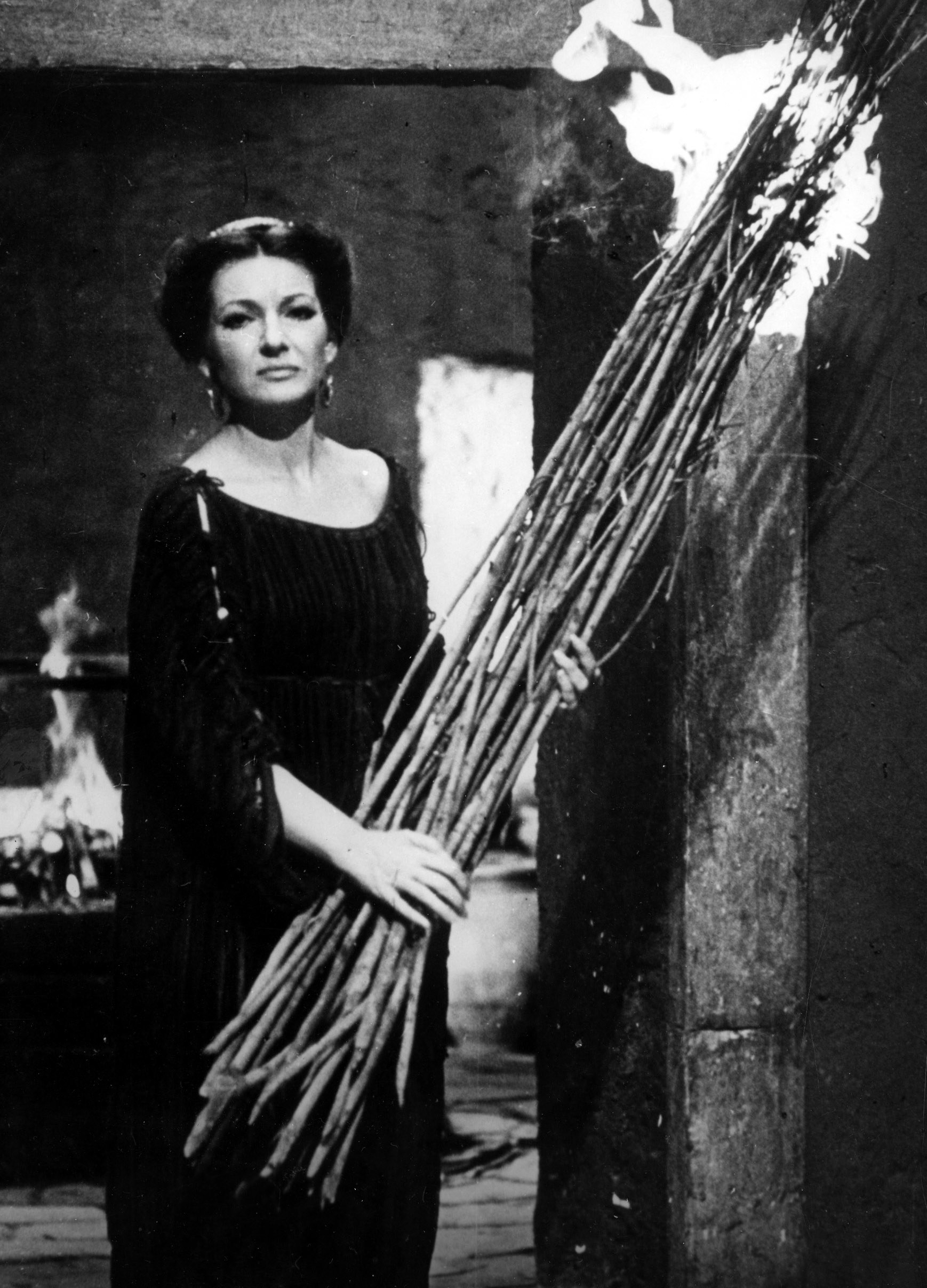 Medea carries a bundle of burning sticks