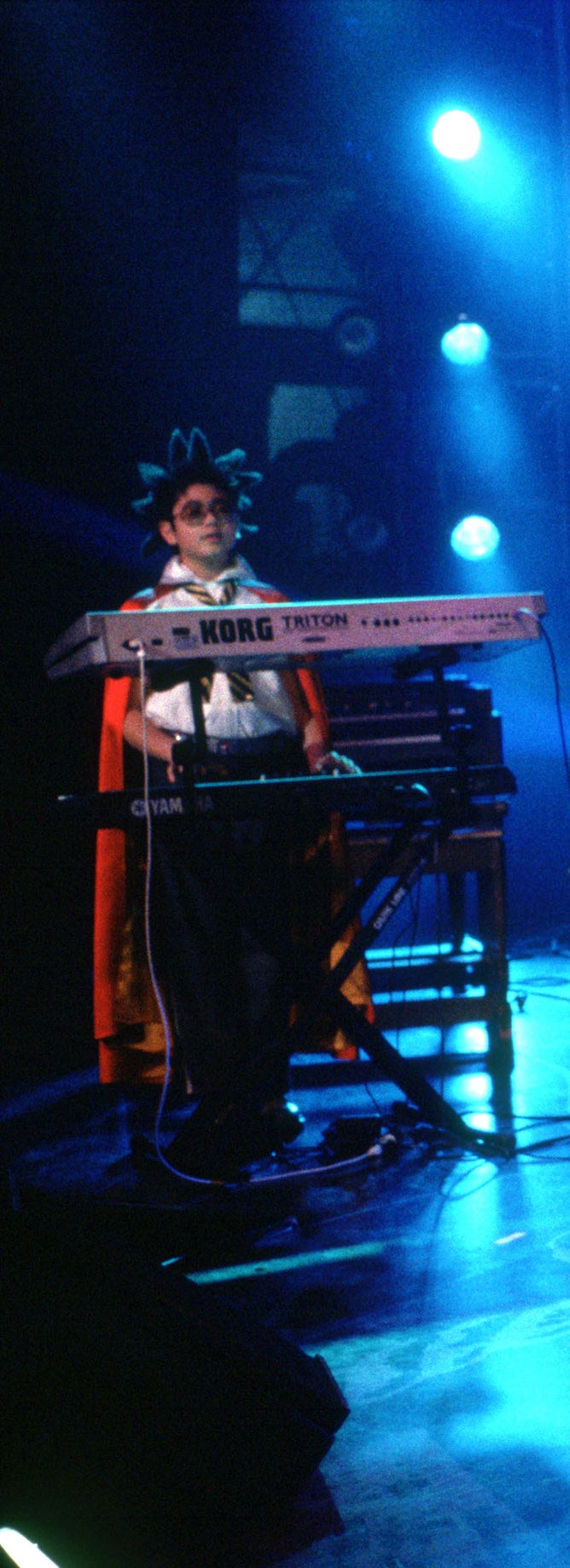 Lawrence plays piano on stage with the band
