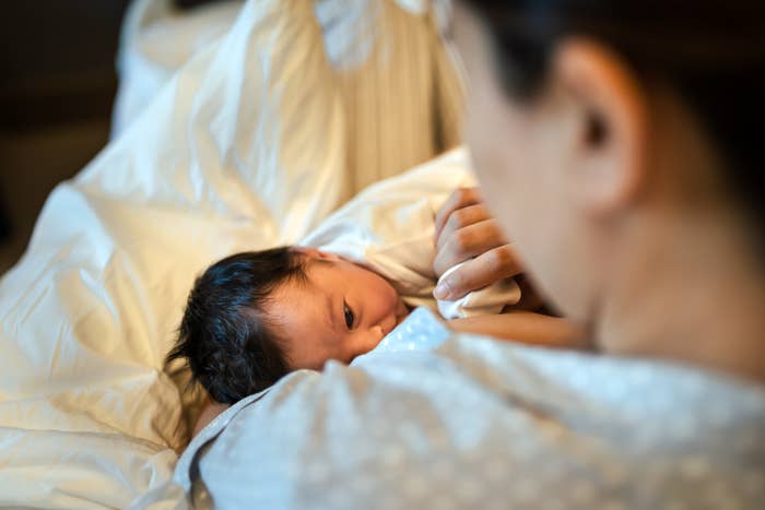 A woman breastfeeding her newborn baby